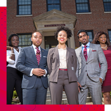 Group of NCCU students posing on campus in professional attire.