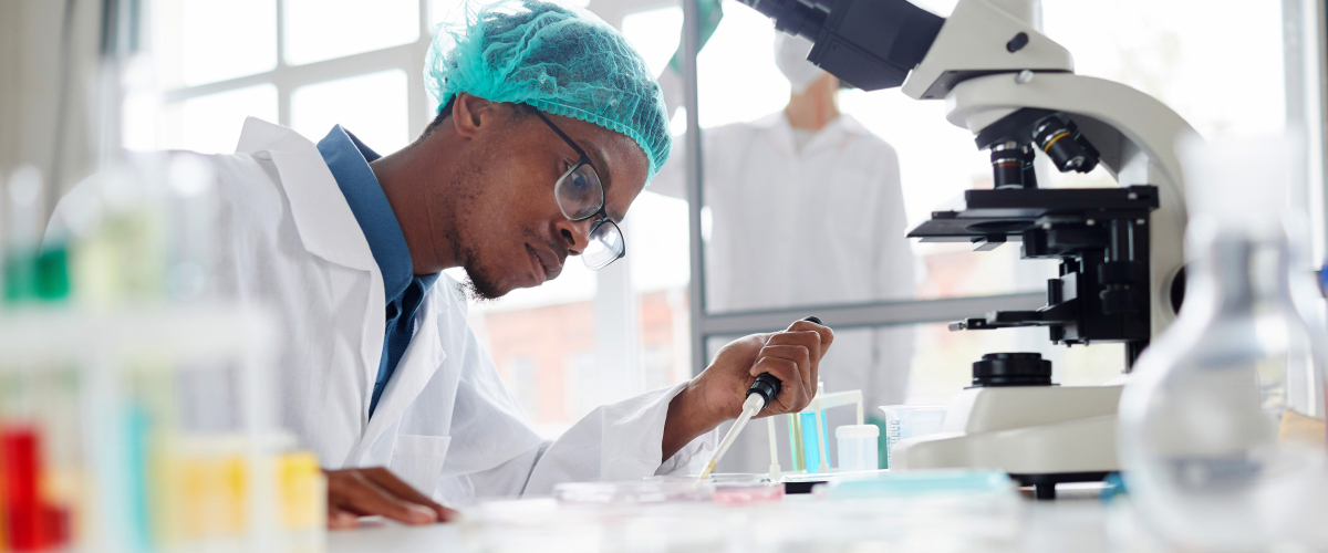 Young male African American researcher working in lab